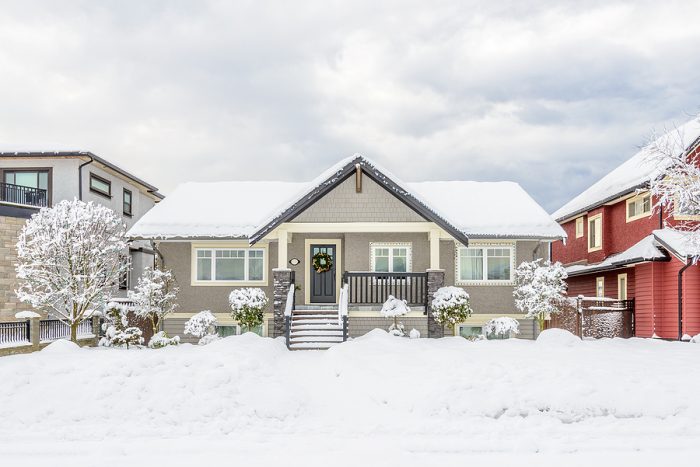 A Typical American House In Winter. Snow Covered.